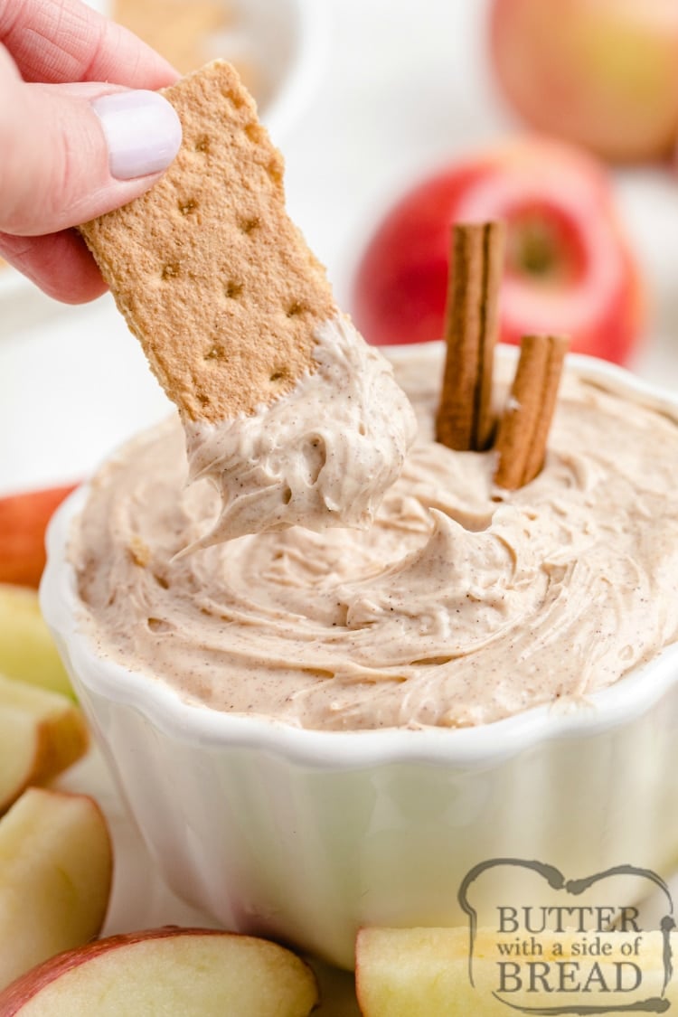 Dipping graham crackers in snickerdoodle cream cheese dip