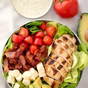 grilled chicken on a BLT salad with a side of creamy pesto ranch dressing