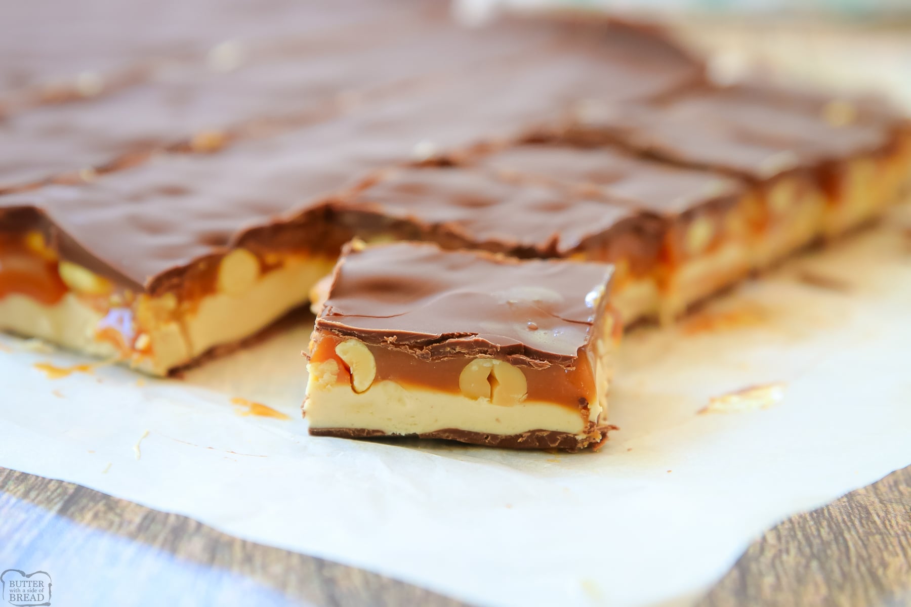 bars of homemade Snickers in a pan