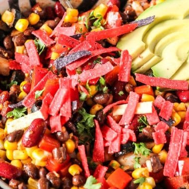 Easy Taco Salad Recipe loaded with beans, corn, peppers, onions, tomatoes and perfectly seasoned! Simple vegetarian taco salad to whip up for an easy dinner or for a potluck!