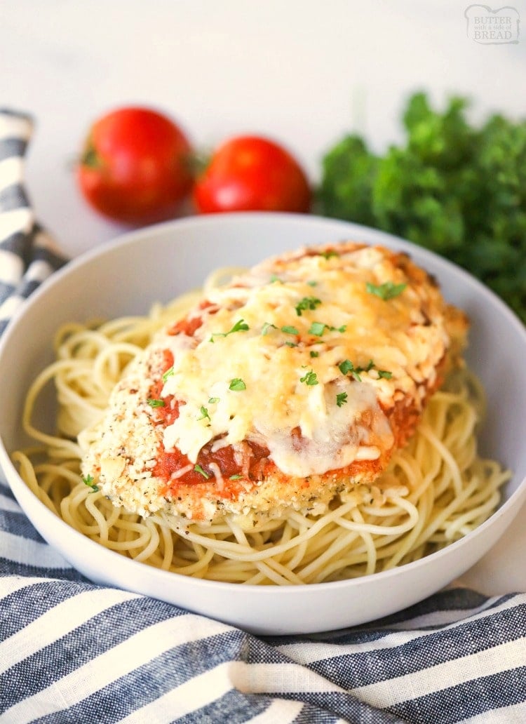 Baked parmesan chicken on top of spaghetti noodles