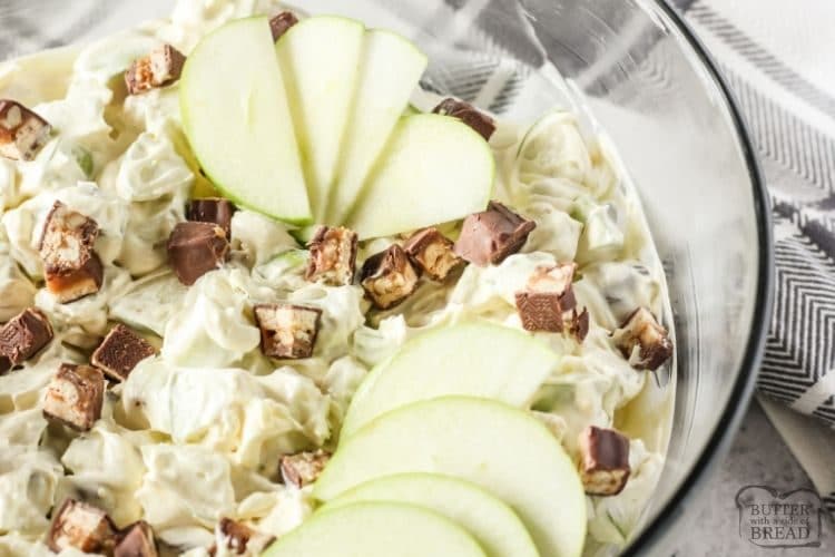 salad with snickers and apples in a glass bowl