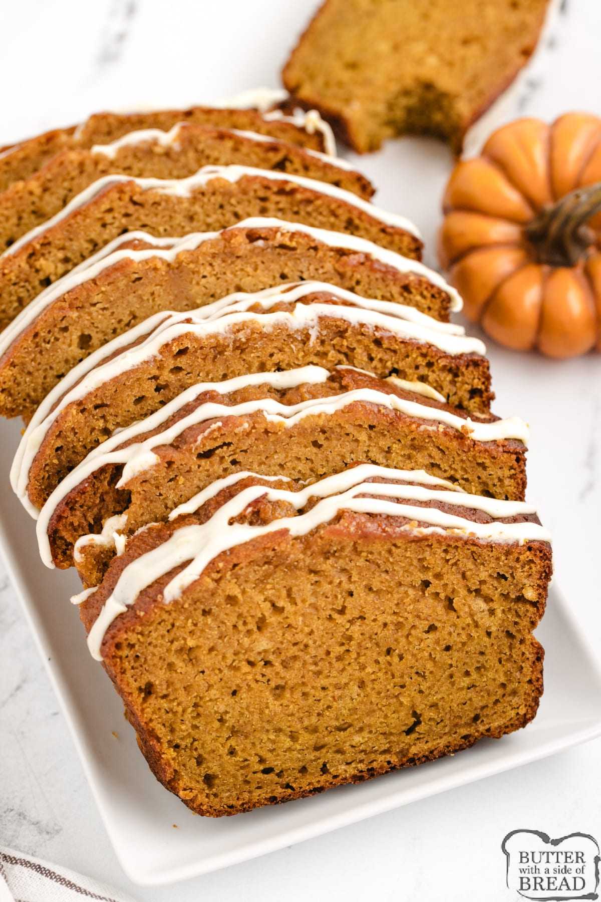 Best Pumpkin Bread that is made with canned pumpkin, vanilla and butterscotch pudding mixes. This deliciously moist pumpkin quick bread recipe is also topped with a delicious cream cheese glaze!