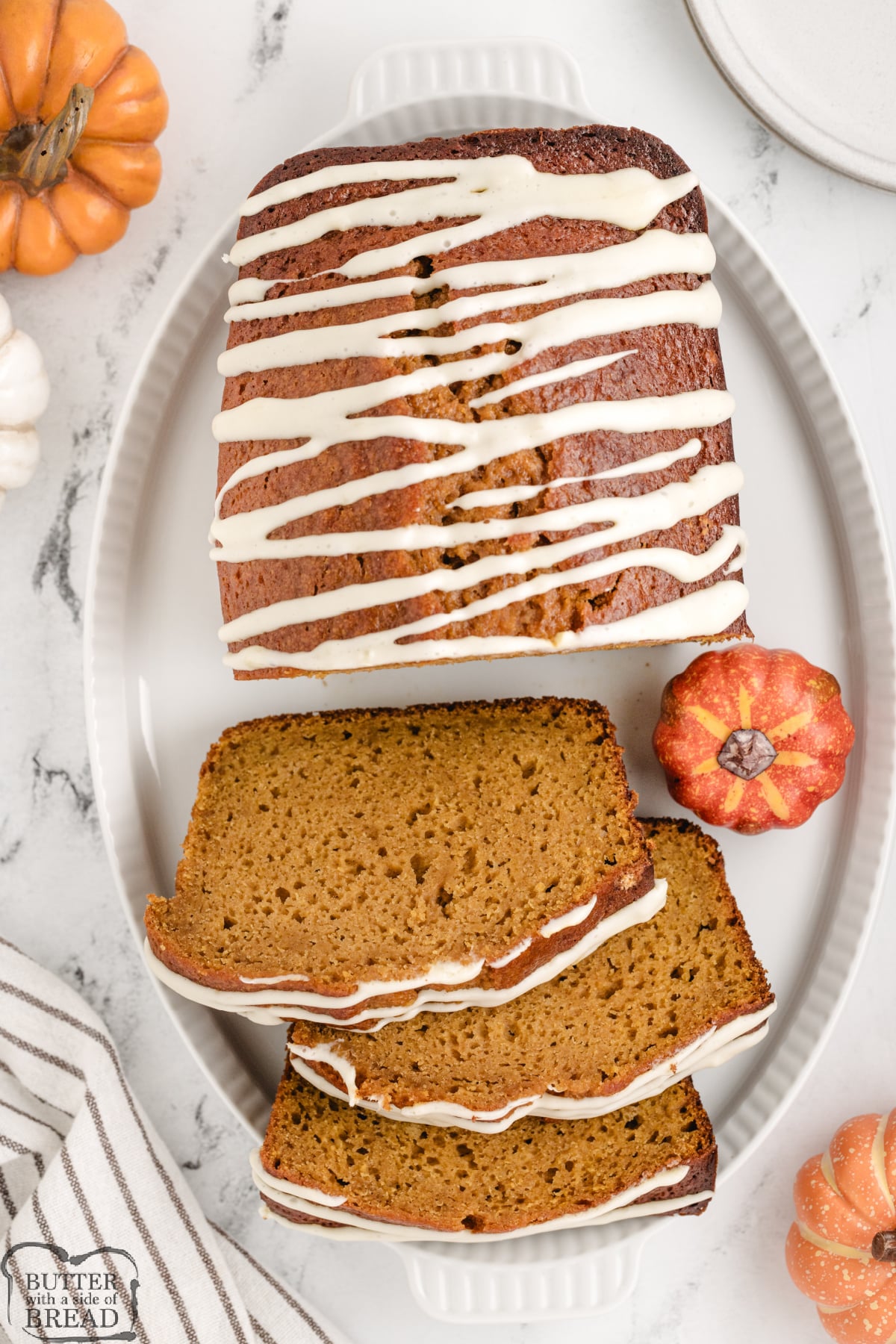 Slices of pumpkin bread with cream cheese frosting.