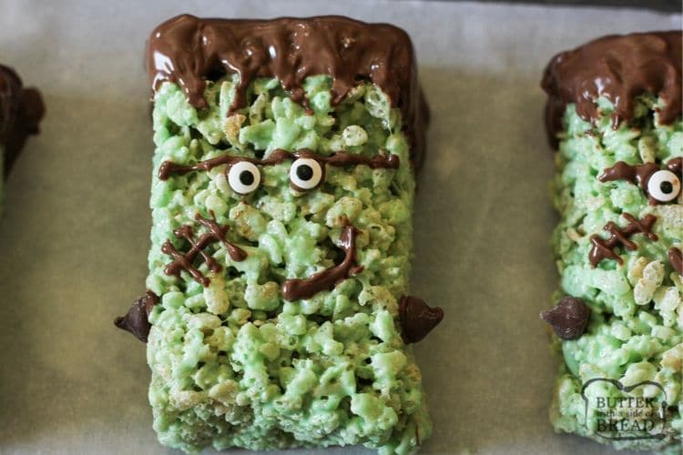 Frankenstein Rice Krispie Treats are cute green Krispie treats dipped in chocolate & made into Frankensteins! Simple Halloween rice Krispie treats perfect for Halloween Parties!