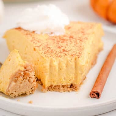 slice of skinny pumpkin cheesecake topped with whipped cream