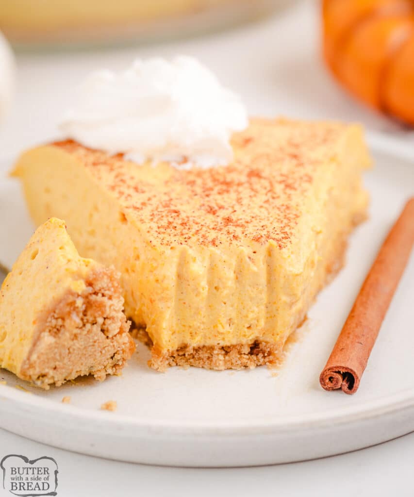 slice of skinny pumpkin cheesecake topped with whipped cream