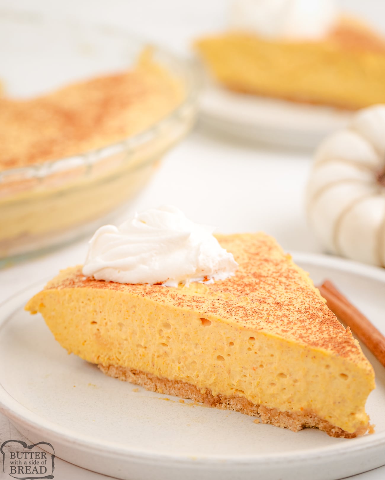 slice of skinny pumpkin cheesecake topped with whipped cream