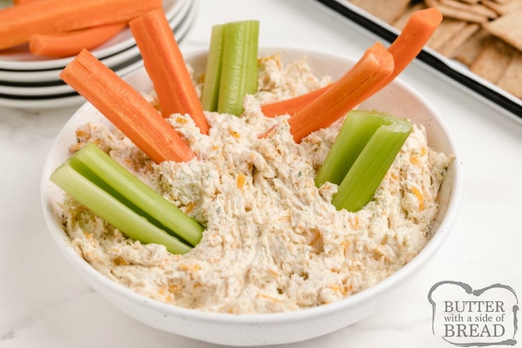 Dipping carrots and celery in ranch dip with chicken and cheese
