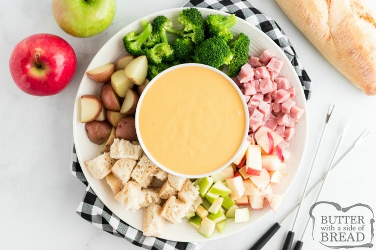 Simple cheese fondue recipe with potatoes, broccoli, apples, ham and bread