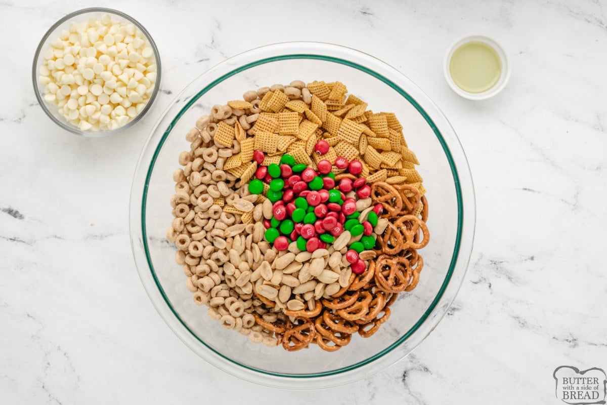 Chex cereal, Cheerios, pretzels, peanuts and M&Ms in a bowl. 