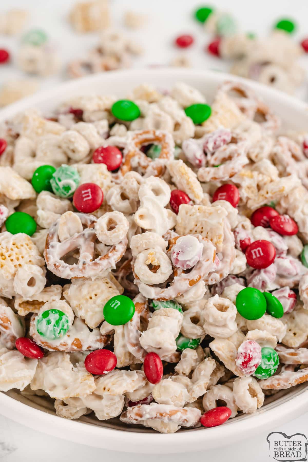 White Chocolate Chex Mix is made with cereal, pretzels, peanuts and M&Ms all coated in white chocolate. This easy white chocolate chex mix recipe is salty and sweet and comes together in less than 5 minutes!