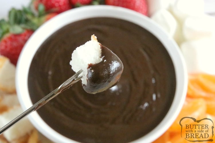Dipping angel food cake into chocolate