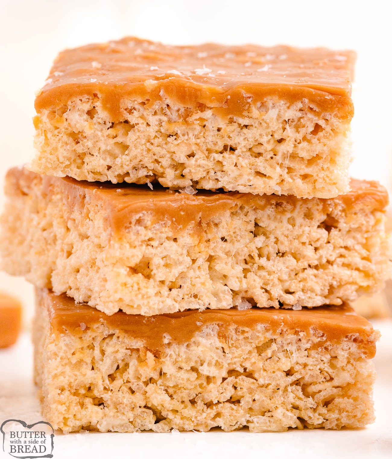stack of 3 rice krispie treats covered in salted caramel