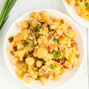 Bacon Breakfast scramble is an easy skillet breakfast casserole recipe everyone enjoys. Protein packed with eggs, bacon and hash brown potatoes, this scramble comes together fast and can feed a crowd! 