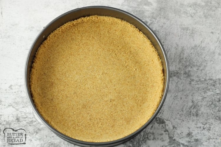 graham cracker crust in the bottom of a round pan