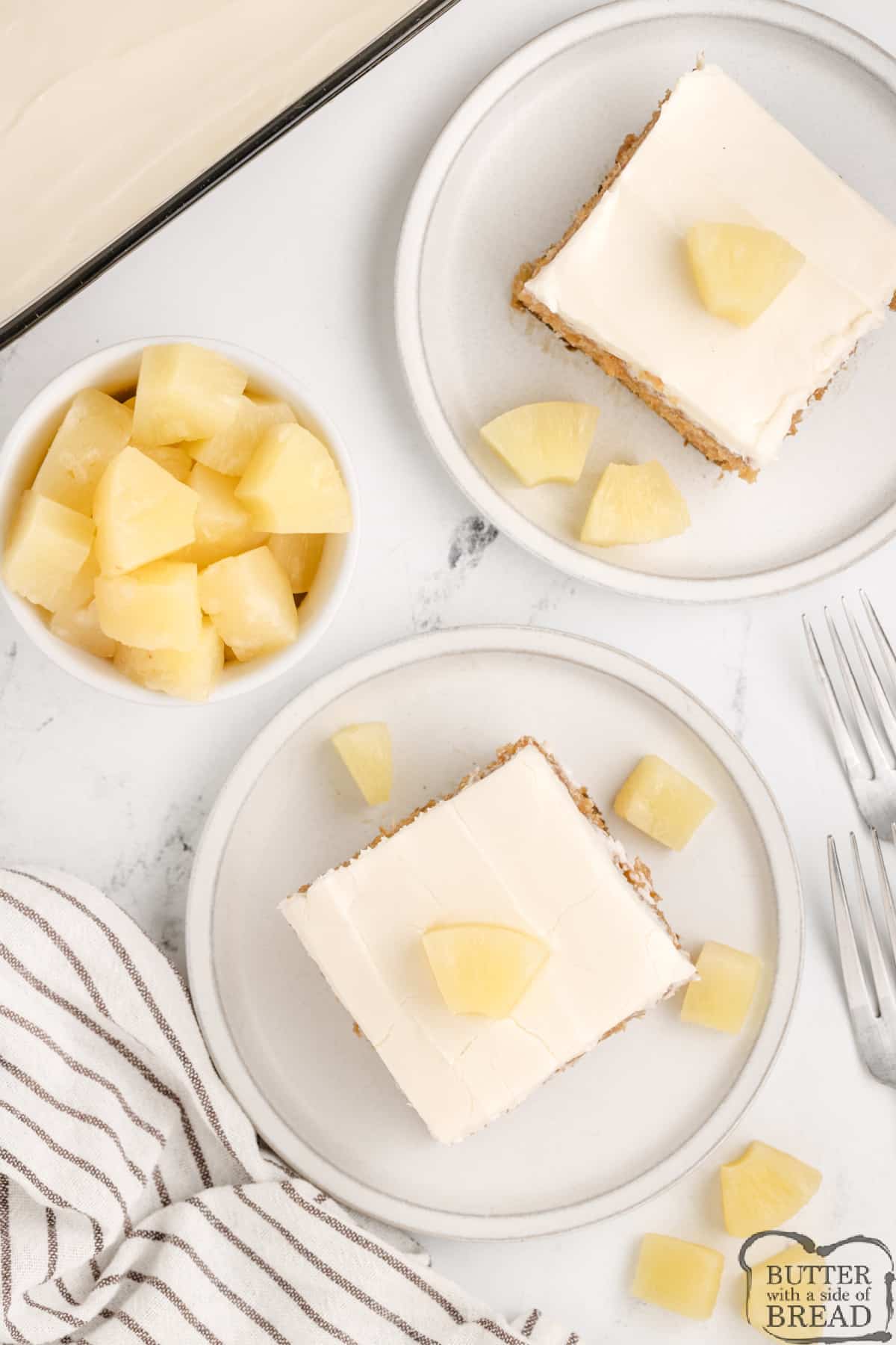 Slices of pineapple cake with cream cheese frosting.