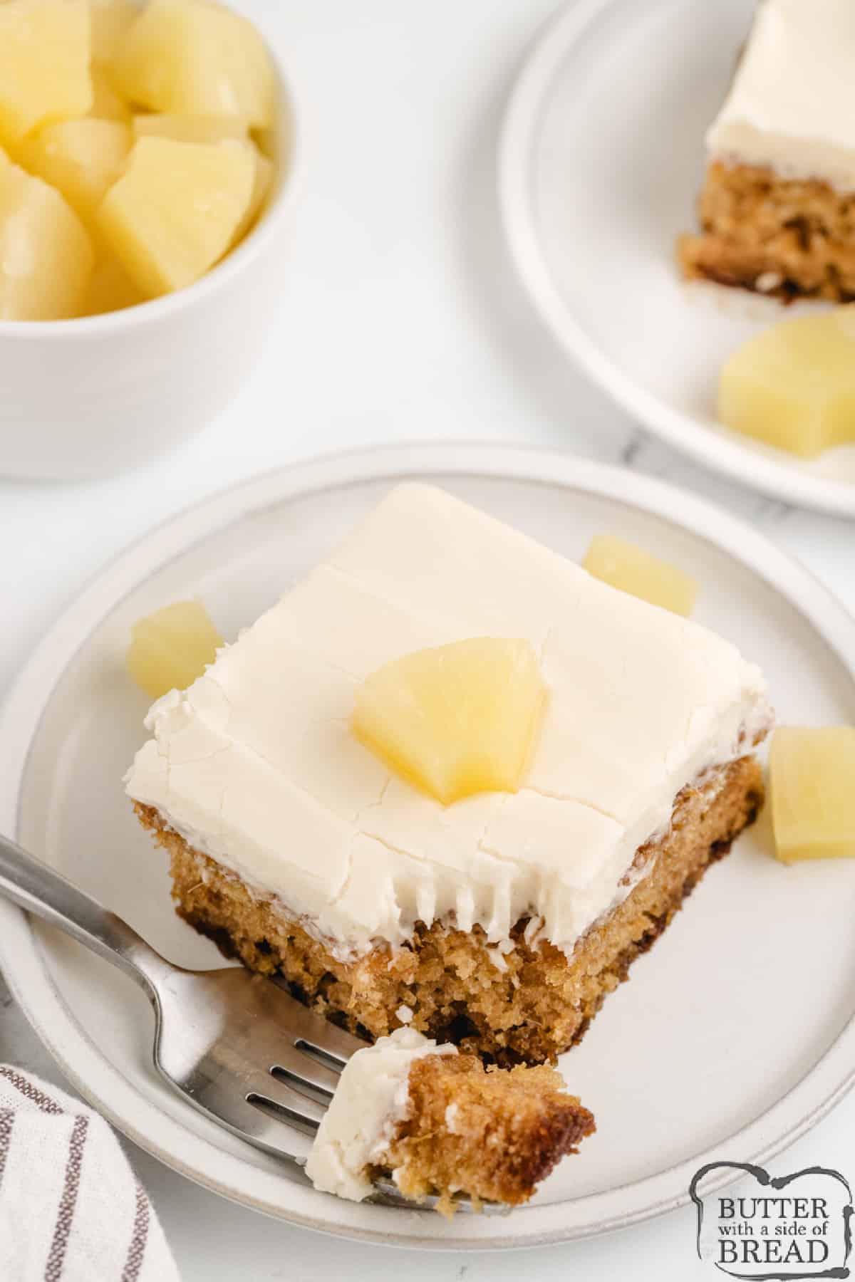 Slice of pineapple cake with cream cheese frosting. 