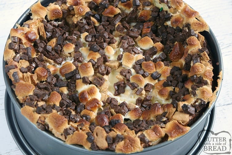 Cheesecake topped with marshmallows, graham cracker chunks and chopped Hershey bars
