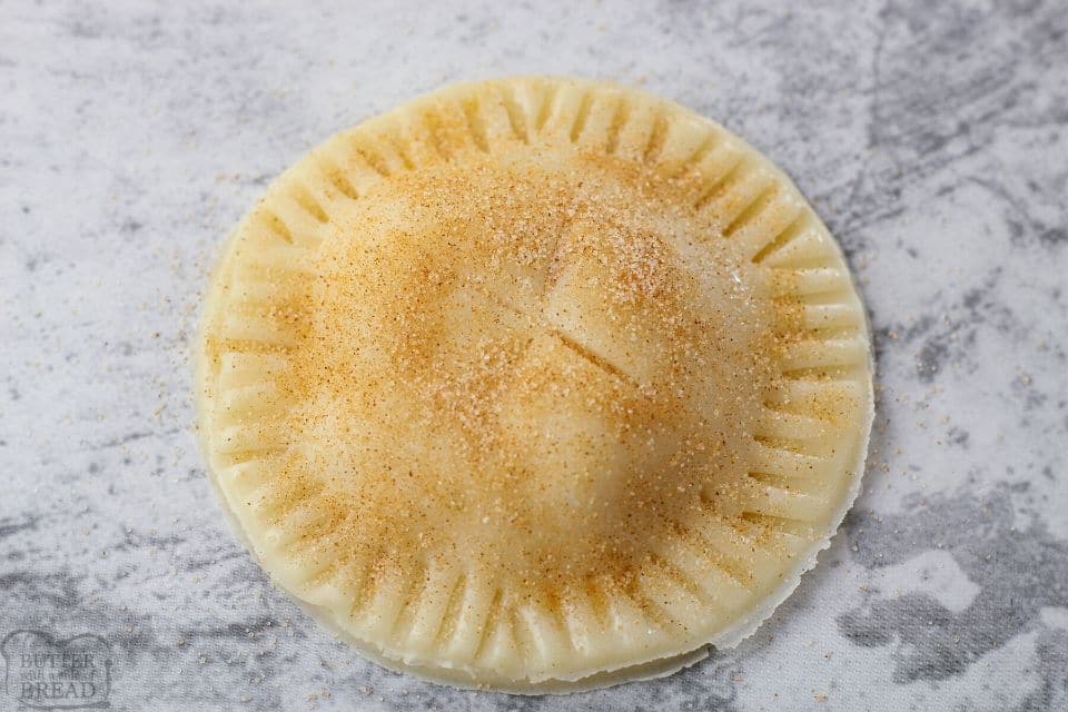 small apple pie with cinnamon sugar on time before baking