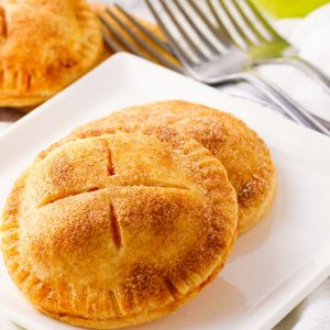 Mini Apple Pies are a simple 4 ingredient dessert made with flaky pie crust & apple pie filling. Lovely tastes of apple pie only so much easier to make! Perfect for making ahead and taking along to parties and family get togethers.