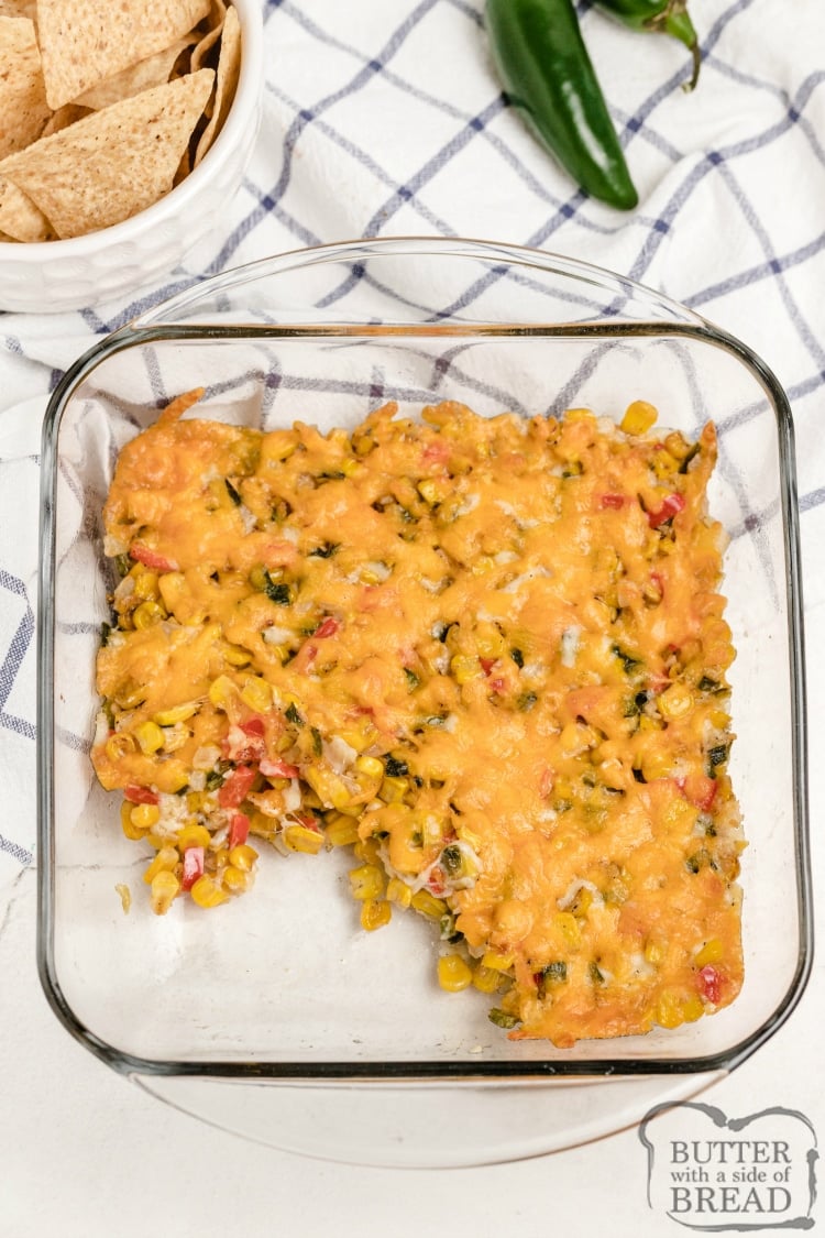 Cheesy Baked Corn Dip is full of fresh corn, veggies and cheese for an easy corn dip recipe that is bursting with flavor. Perfect chip dip that everyone will love!