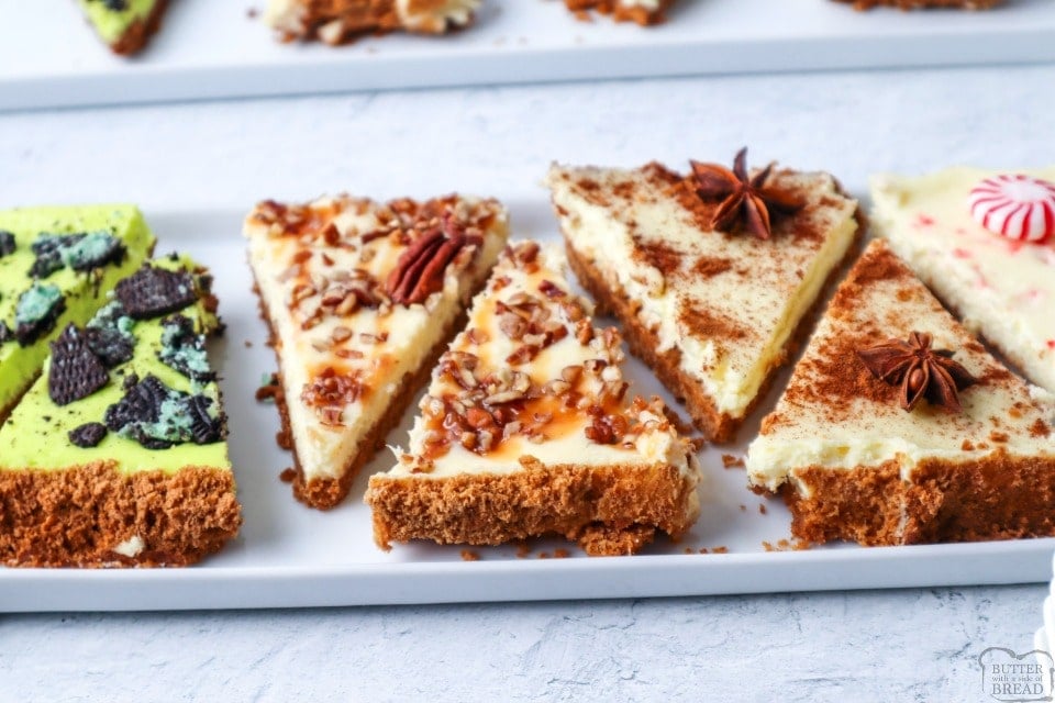 This easy sheet pan cheesecake recipe is one to remember. With just one simple graham cracker crust and a basic cheesecake batter we can create holiday cheesecake bars with 4 flavor options to choose from!   1 sheet pan and 4 delicious flavors of homemade cheesecake made conveniently on a sheet pan. Serve it up at your next holiday party and watch them disappear!