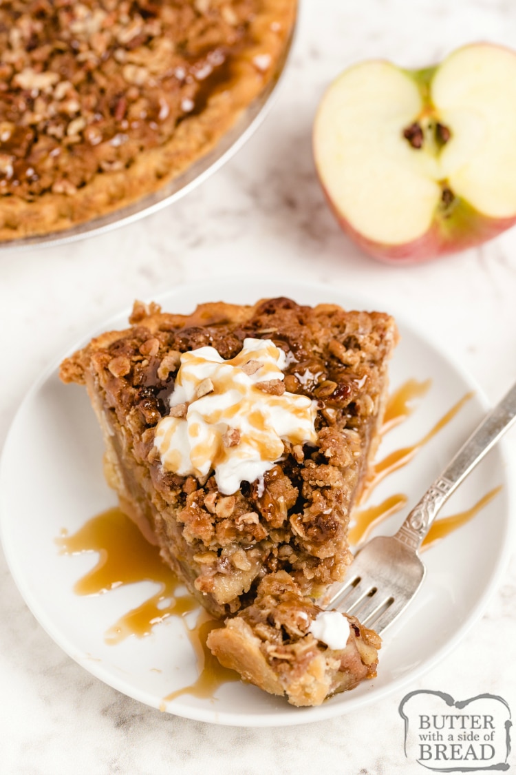 Slice of apple pie with caramel, pecan and oat topping