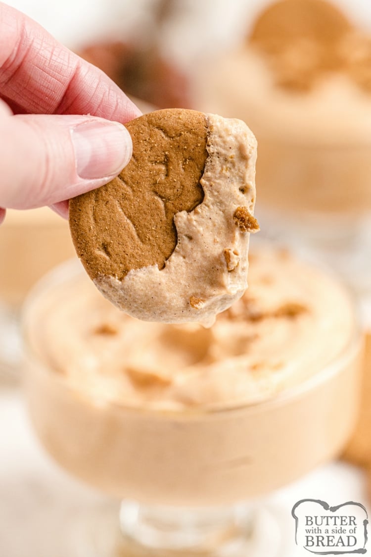 Dipping a gingersnap cookie in easy pumpkin fluff recipe