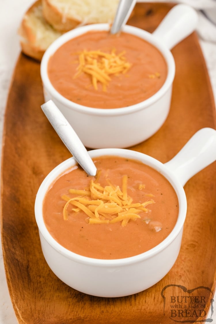 Cheesy Tomato Soup is smooth, creamy and so easy to make! Tomatoes, melted cheddar and sauteed veggies give this easy tomato soup recipe tons of flavor. 
