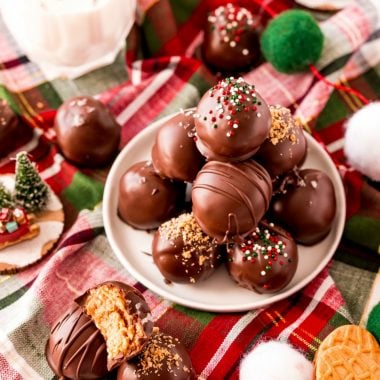 Nutter Butter Truffles made with 5 basic ingredients & perfect for holiday goodie trays! Festive, easy cookie balls with Nutter butters, cream cheese, peanut butter & chocolate! 