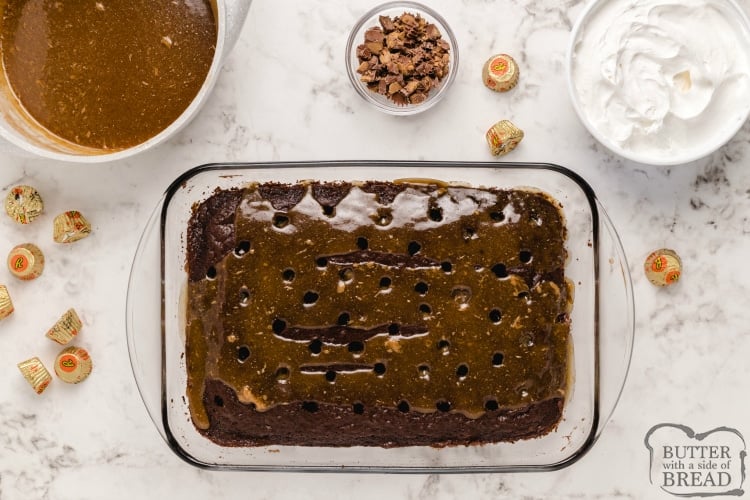Pouring caramel peanut butter sauce over chocolate poke cake