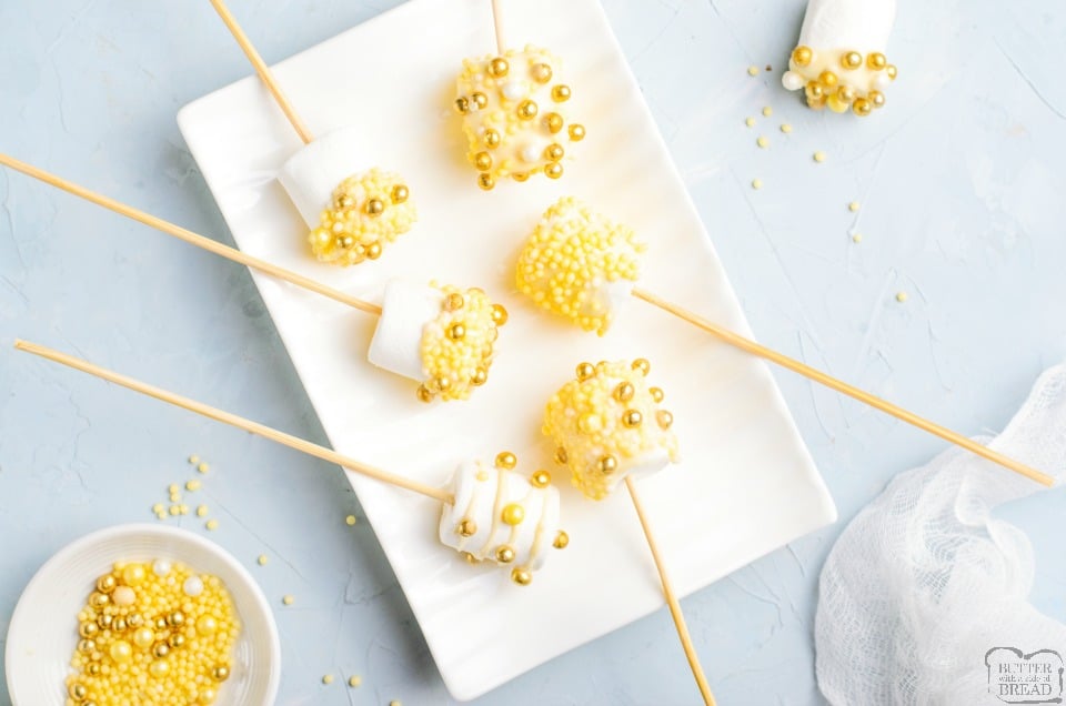 White Chocolate Covered Marshmallow Pops made with gold sprinkles for a simple, festive New Year's treat! Easy recipe for festive chocolate dipped marshmallows!