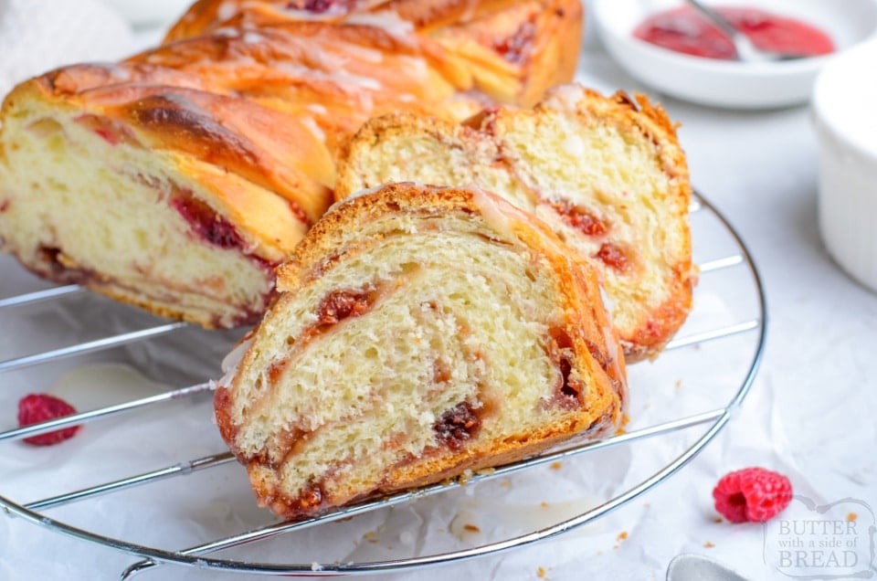 Raspberry Twist Bread is a delicious loaf of homemade sweet bread swirled with raspberry jam. Served with lemon icing and brioche-style dough this bread is perfect for breakfast or dessert!