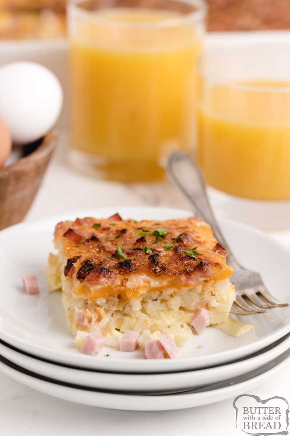 Breakfast casserole with eggs, cheese and ham with a hash brown crust