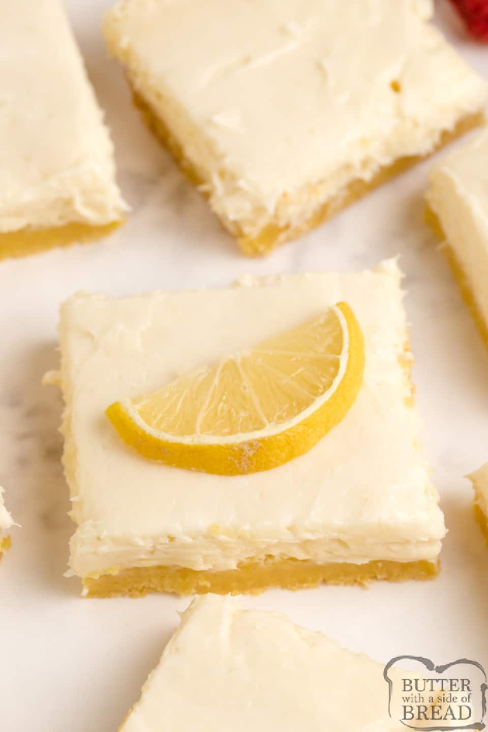 Lemon Cream Cheese Bars with a lemon cake mix crust, a vanilla cream cheese filling and a lemon cream cheese topping. Simple and delicious layered lemon bar recipe!