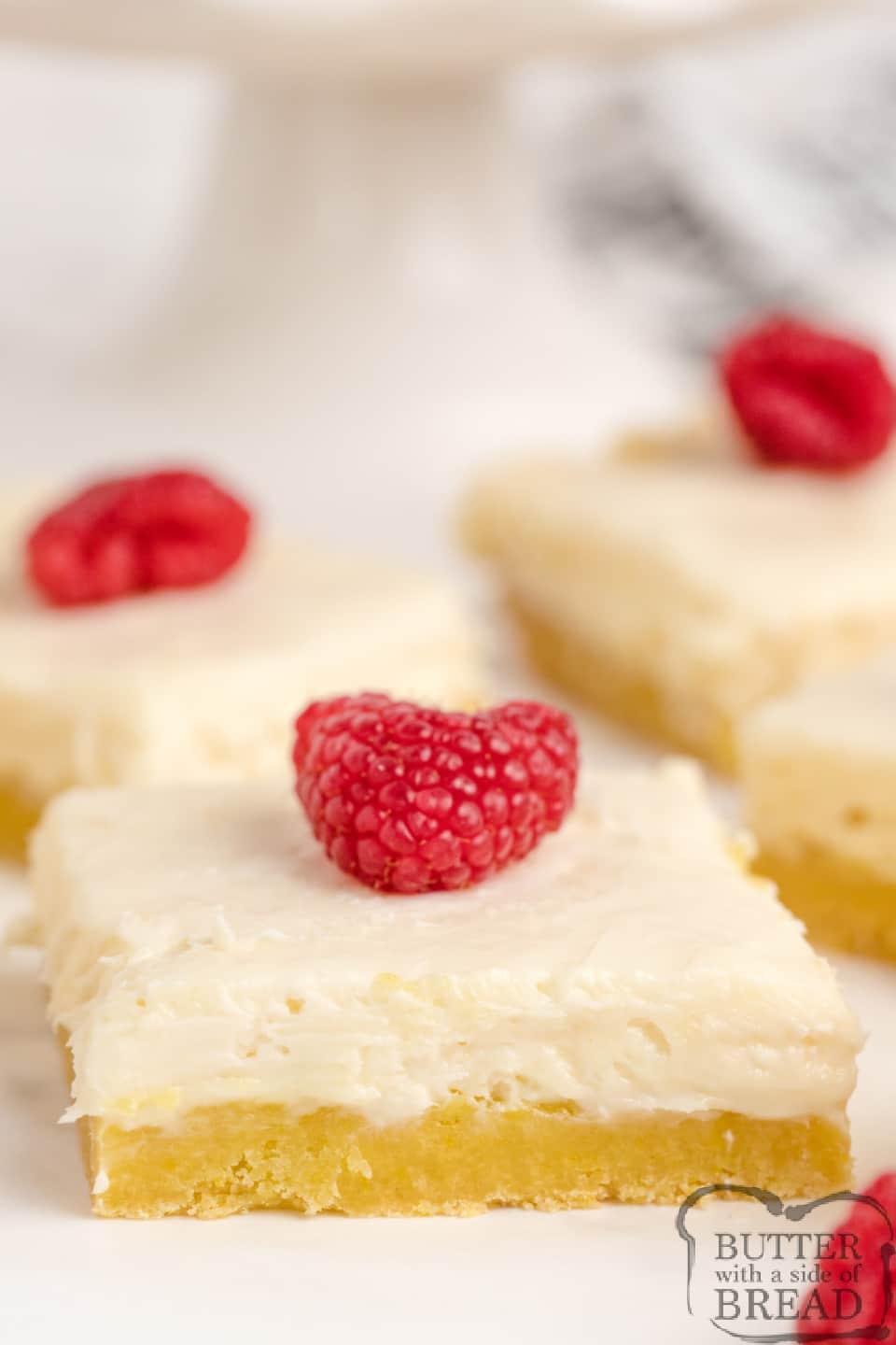 Layered lemon bars with a lemon cake mix crust, and two different cream cheese layers on top
