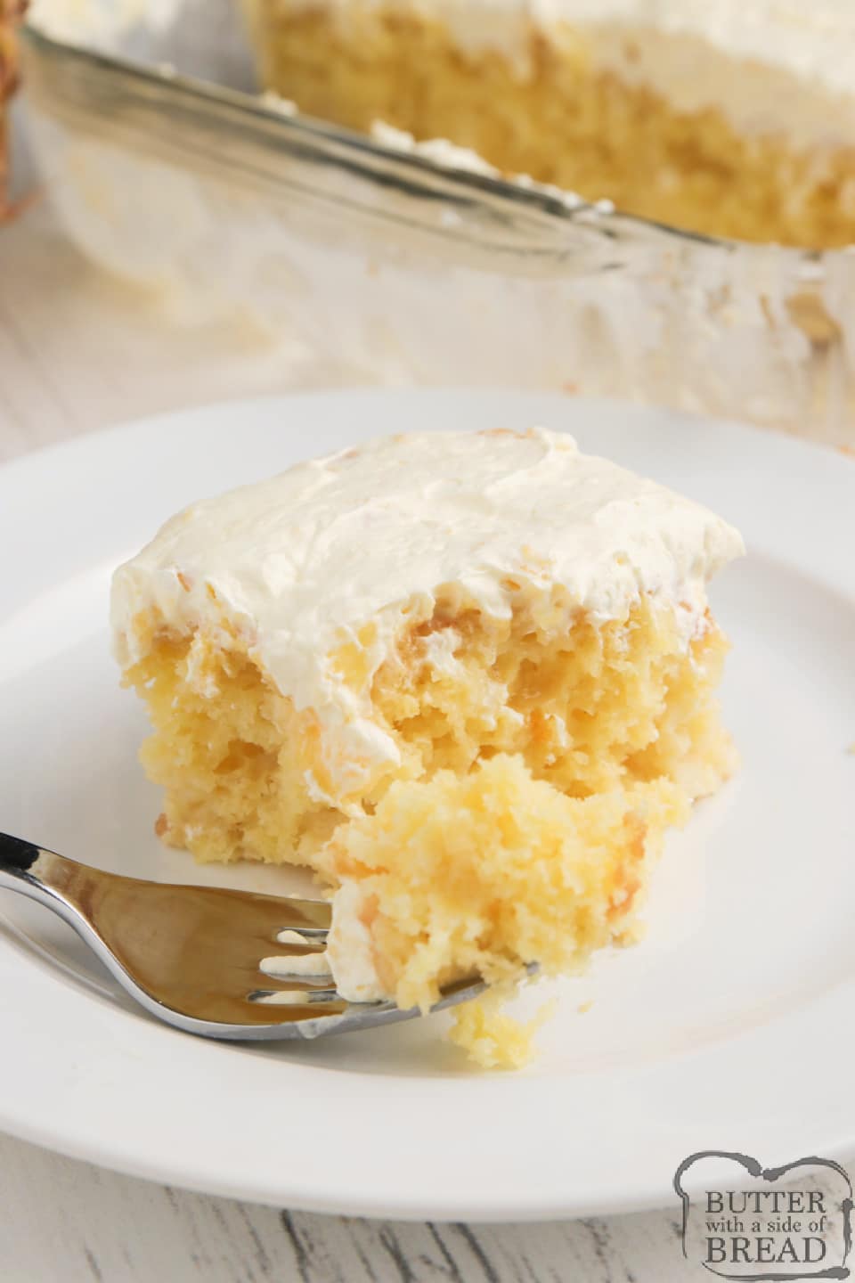 Pina Colada Poke Cake made with a cake mix, crushed pineapple and a delicious, creamy pina colada sauce. Easy poke cake recipe topped with a light, refreshing pineapple pudding topping.