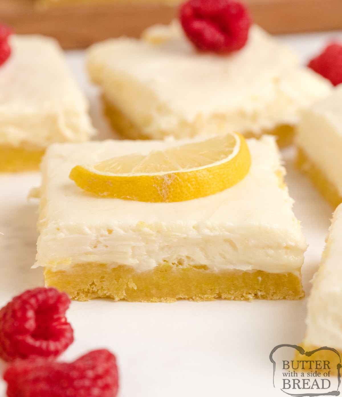 Layered lemon cream cheese bars with a cake mix crust and creamy lemon topping.