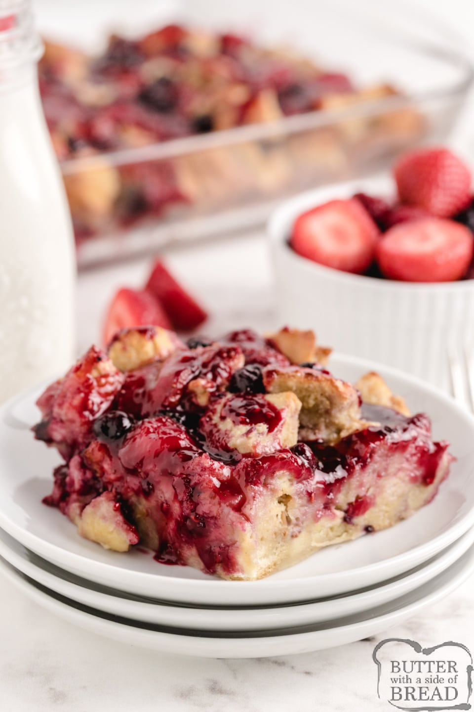 Berry French Toast Bake is made with french bread, eggs, cream, fresh strawberries and frozen mixed berries. This baked french toast recipe is simple, delicious and perfect for breakfast or dinner!