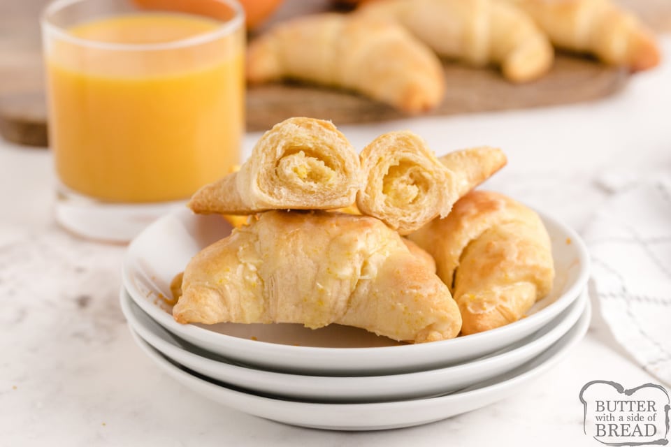Orange Breakfast Crescents made with refrigerated crescent rolls stuffed with a cream cheese filling and topped with a sweet orange frosting! Taste just like orange rolls, but are ready in less than 20 minutes!