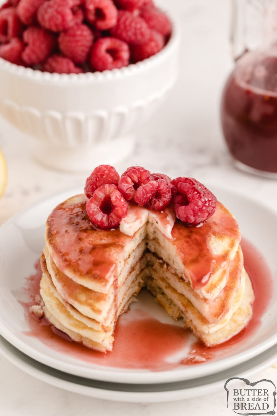 Lemon Pancakes with Raspberry Syrup are light and fluffy with a subtle lemon flavor. Top with a simple two-ingredient raspberry syrup made with frozen raspberries for a delicious pancake breakfast.
