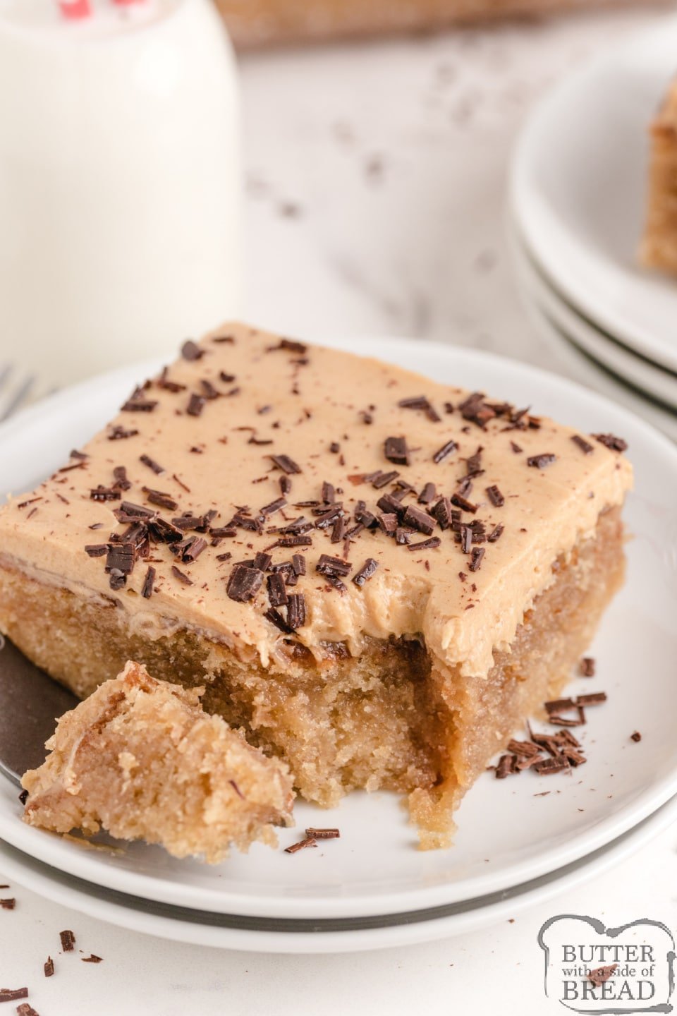 Peanut Butter Poke Cake made from scratch with a delicious peanut butter drizzle and a light peanut butter frosting on top! Tons of peanut butter flavor in this amazing poke cake recipe!