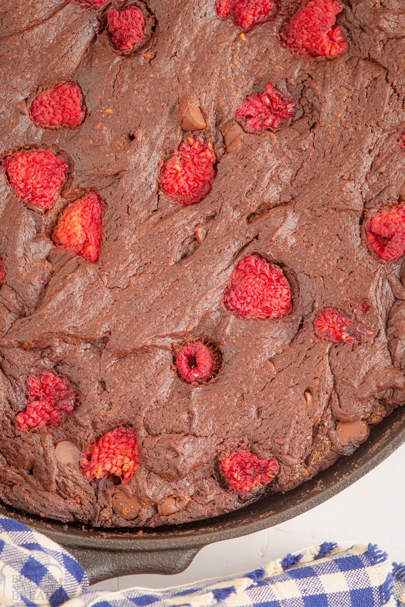close up of raspberry brownies in a cast iron skillet