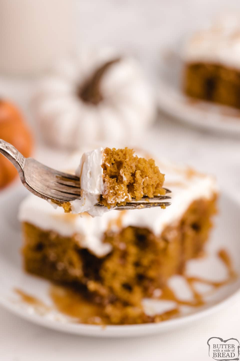 Caramel Pumpkin Poke Cake made with a cake mix, pumpkin, caramel and a simple cream frosting on top! Deliciously decadent poke cake recipe that is perfect for fall.