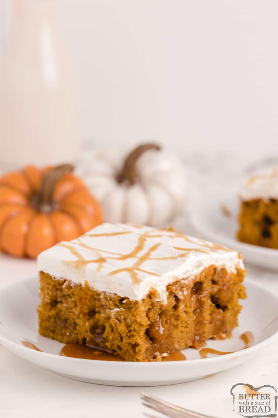 Caramel Pumpkin Poke Cake made with a cake mix, pumpkin, caramel and a simple cream frosting on top! Deliciously decadent poke cake recipe that is perfect for fall.