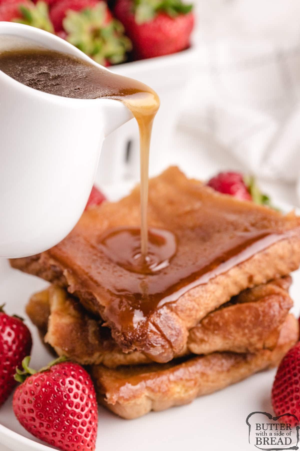Pouring syrup on baked french toast.