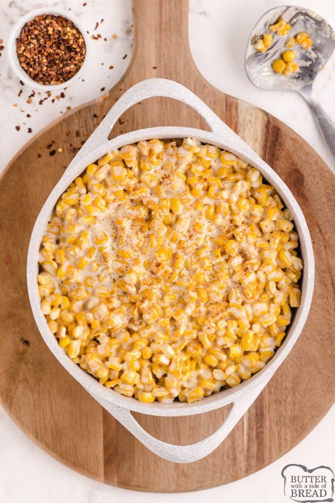 easy homemade creamed corn recipe in a saucepan on a wooden tray