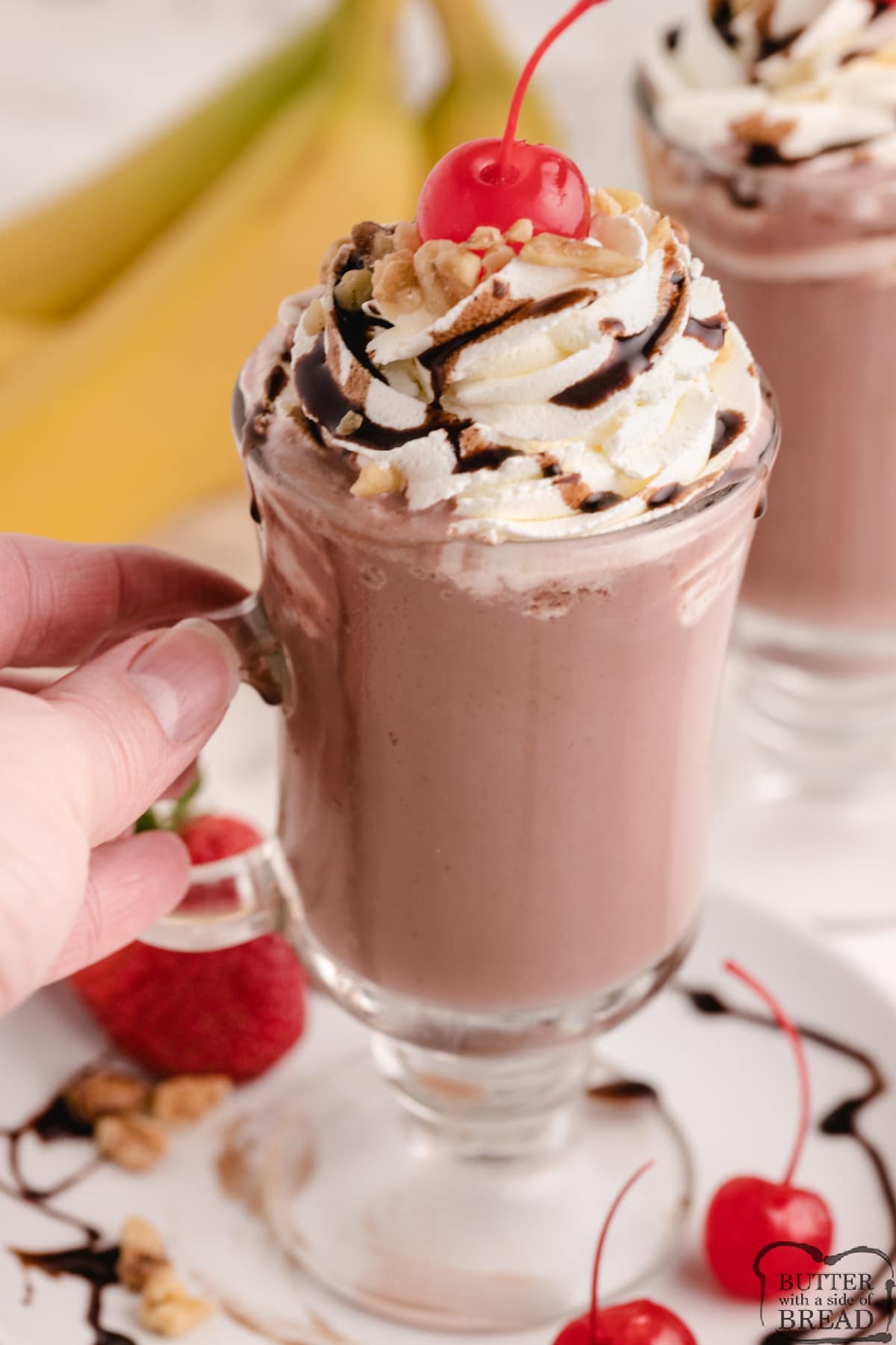 Banana Split Hot Chocolate tastes just like your favorite banana split dessert, but in a mug! Made with hot cocoa mix, bananas, whipped cream, cherries and nuts. 
