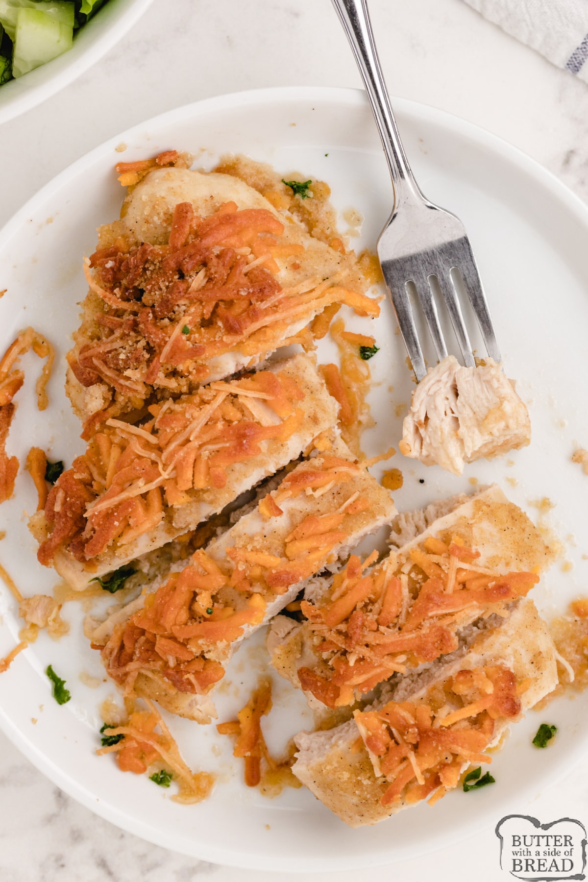Baked chicken coated in cheese and bread crumbs